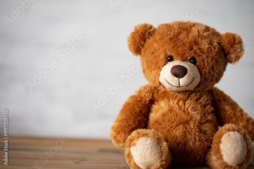 Soft Brown Bear Sitting on a Light Surface With a Neutral Background Indoors
