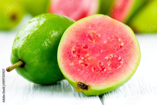 Fresh Guava Sliced Open on Dark Background Showing Pink Flesh and Seeds