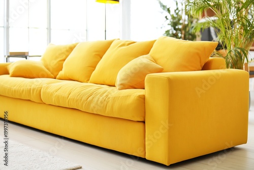 Bright Yellow Sofa in a Living Room With Natural Light and Green Plants Durin...