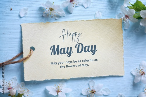Happy May Day greeting card with handwritten message and cherry blossoms on pastel blue wooden background