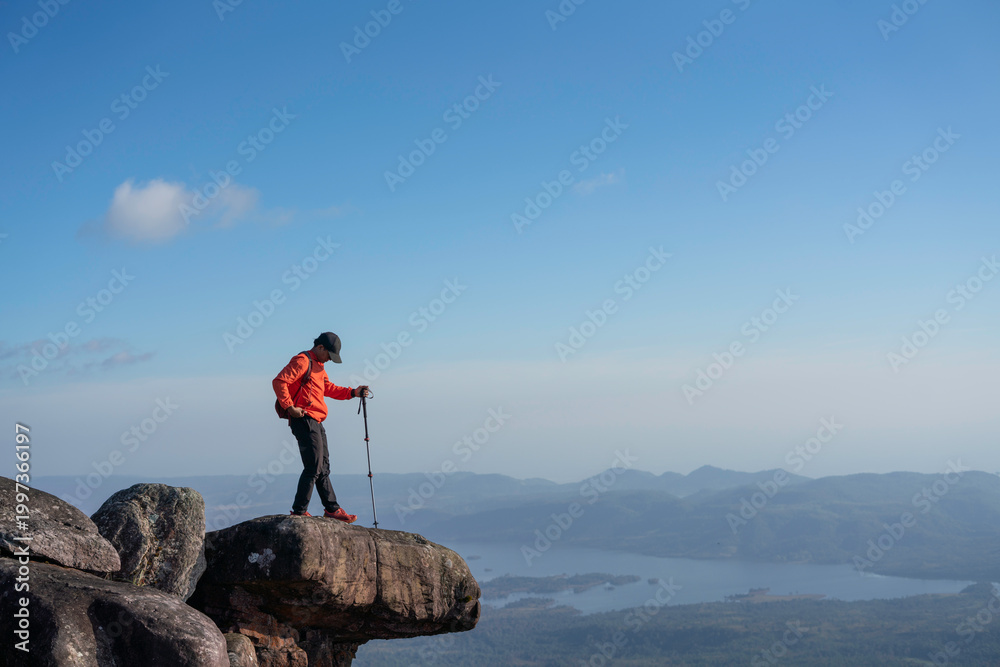 Obraz premium Adventurous hike on rocky summit scenic mountains outdoor activity clear skies dramatic viewpoint nature exploration