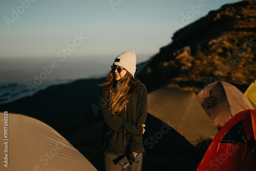 Adventure enthusiast at sunrise camp mountain range photography outdoor close-up freedom and exploration