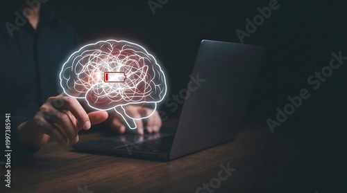 Immersive brain hologram with low energy indicator processed on laptop to optimize corporate mental wellness strategies in dark office.