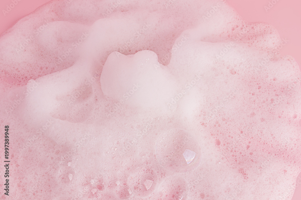 Fototapeta premium Chic white fluffy foam, soap foam texture, shampoo on a pink background. Layout for advertising detergents, spa cosmetics. A copy space