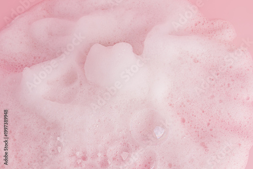 Chic white fluffy foam, soap foam texture, shampoo on a pink background. Layout for advertising detergents, spa cosmetics. A copy space