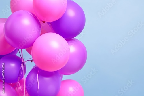 Bright Balloons in Pink and Purple Colors Floating Against a Blue Background ...