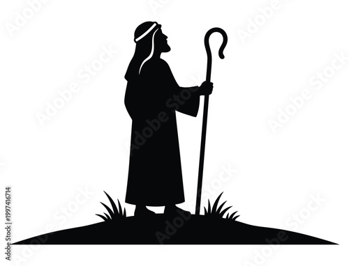 Shepherd silhouette with staff standing on a hill