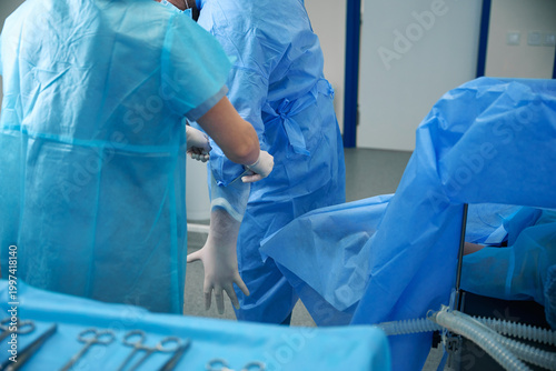 Two medical professionals in operating room during surgery