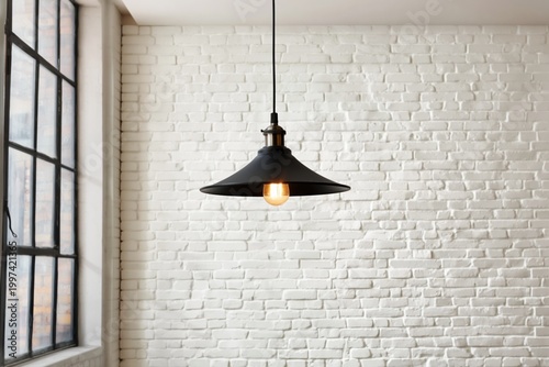 Unique Black Pendant Light Hangs From Ceiling in Modern Room With White Brick...