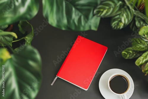 Coffee Cup and Red Notebook on a Table With Plants Around for Inspiration and...