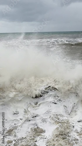 Closeup waves exploding into towering spray, whitewater and mist fill frame, dramatic impact with fine spume and churning motion, cinematic abstract patterns, evokes coastguard on patrol