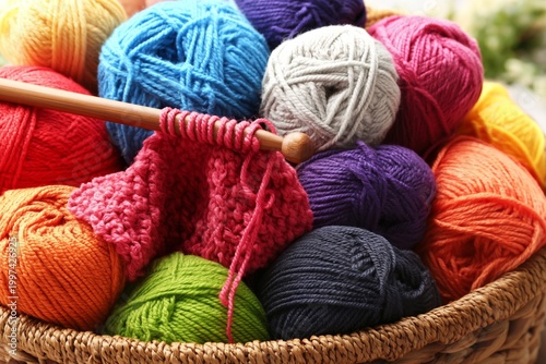 Colorful Yarn in a Woven Basket With Knitting Needles on a Table