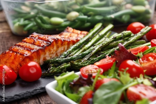 Fresh Grilled Salmon With Asparagus, Tomatoes, and a Salad on a Wooden Table ...