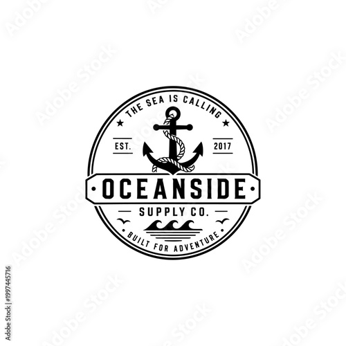 A vintage style black and white circular logo for oceanside supply co with an anchor and rope.