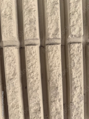 Beige textured wall with vertical pattern