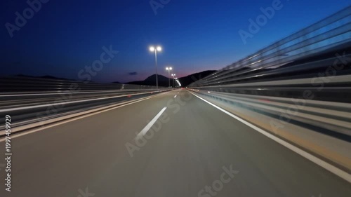 POV driving on modern highway with bright lights illuminating the road at night. Transportation, travel and infrastructure concept, 4k