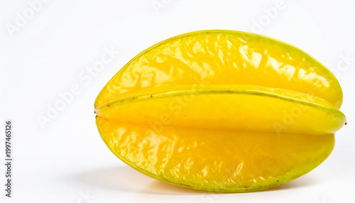 A starfruit cut in half on a white table indoors closeup