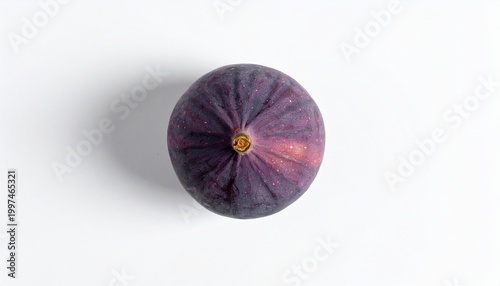 A ripe fig with a vibrant purple color and subtle pink undertones casts a shadow on a clean white surface.