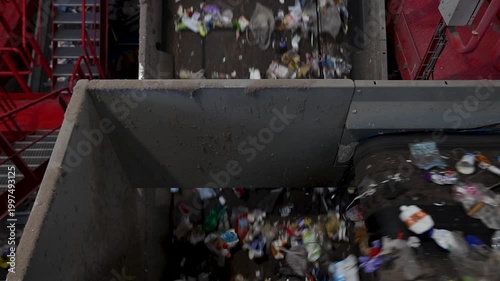 Mixed waste conveyed through central transport line in recycling facility