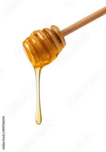 Wooden honey dipper dripping golden sweet natural honey