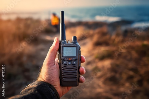 Emergency radio device in hand outdoors