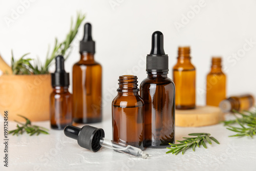 Tableau sur toile Rosemary essential oil on a textured background