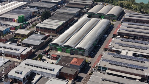 Industrial Panorama: An aerial perspective of an industrial area showcases a complex network of warehouses and buildings. The shot highlights the efficiency and infrastructure.