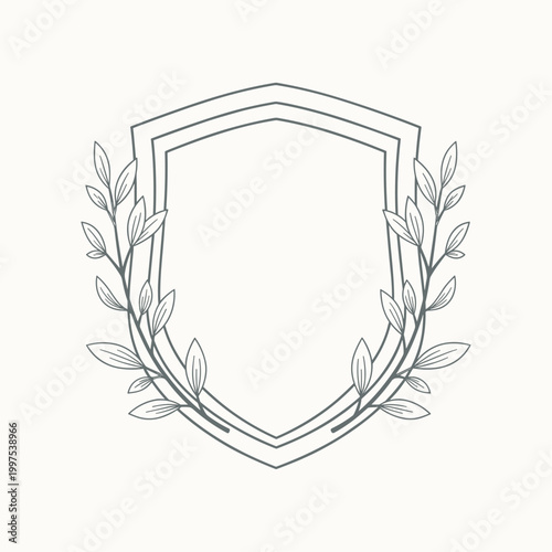 Layered shield emblem with double outline and subtle botanical details