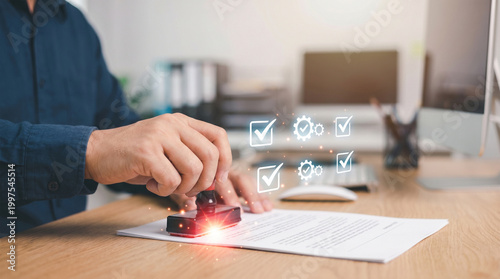 Man using a rubber stamp on a document in an office setting