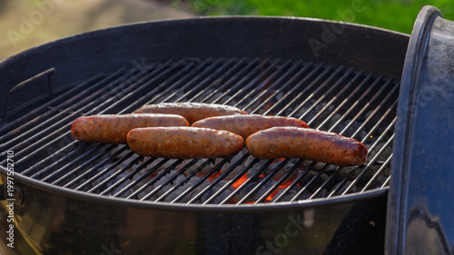 Fotografija Sausage grill outside on trill in a backyard
