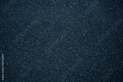 Dark asphalt road texture with rough surface and detailed grain, ideal for background pattern
