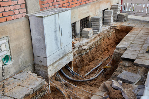 Canvastavla Outdoor electrical distribution box with underground power cables connected through a trench at a residential building construction site