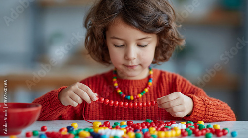 Child threading colorful beads at table
