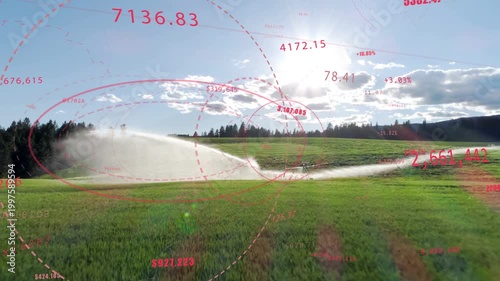 Sprinkler starting spray, water plume sweeping right, HUD graphics animating to show field moisture