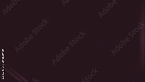 Deep crimson abstract texture with subtle vertical light streaks and scattered dust particles