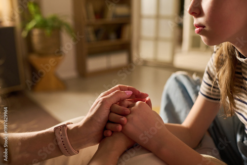 Bilde på lerret Close up of Caucasian mother holding teenage daughter hands, comforting during difficult conversation at home