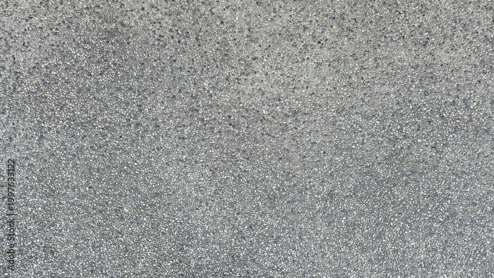 Fototapeta premium Gray gravel concrete floor, road surface, walkway surface, small gravel road surface, texture, and background. Gray exposed aggregate concrete texture with fine pebbles.
