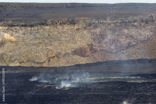 Rugged volcanic crater wall and smoking ground inside the Kilauea caldera at Hawaii Volcanoes National Park Big Island Hawaii