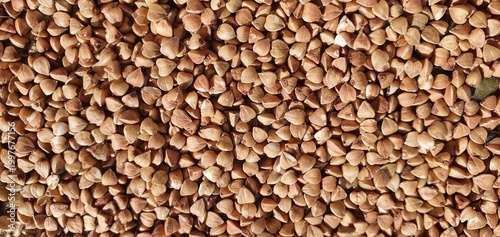 Whole grain buckwheat. Close-up of buckwheat. Buckwheat on burlap. Buckwheat texture. Healthy eating, seeds, grains, diet.
