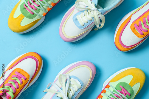 Obraz na płótnie Stylish bright sneakers on light blue background, flat lay