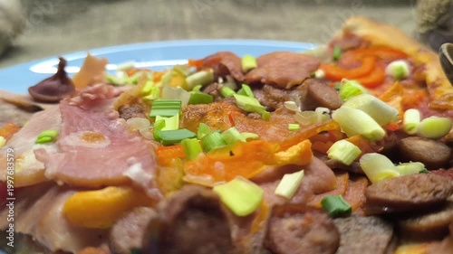 Fresh pizza with tomatoes and olives on a plate