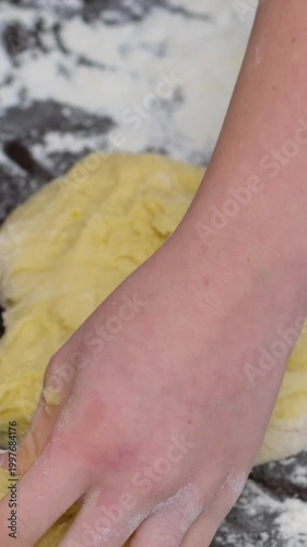 Woman hands dividing dough into portions on floured table baking preparation closeup