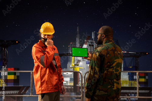 Photos Isolated screen tablet used by soldier protecting strategic national energy assets on drilling barge