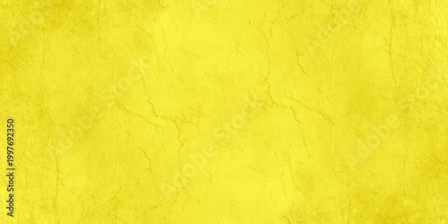 A textured, vibrant yellow surface fills the frame, creating a striking and visually engaging background, full of subtle detail, that evokes feelings of warmth, energy, and creativity.