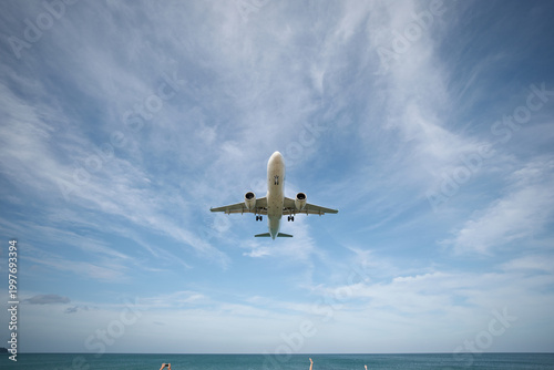 Valokuva A huge passenger plane is landing in airport of Phuket, Thailand, a bottom view