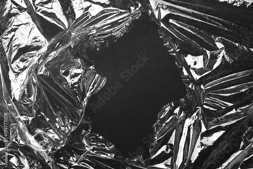 Cuadro en lienzo Torn plastic wrap on black background, top view. Space for text