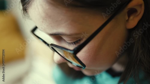 Tired little girl putting on glasses with exhausted eyes, overworked child student rubbing eyes, 4K 10-bit