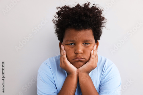Tableau sur toile Portrait of resentful little boy on light grey background