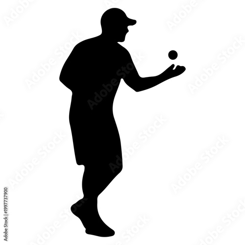 Silhouette of a man playing bocce ball.