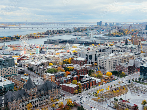 Billede på lærred Aerial view of Montreal with bridges over St Lawrence River, autumn colors, Old Port and marina skyline